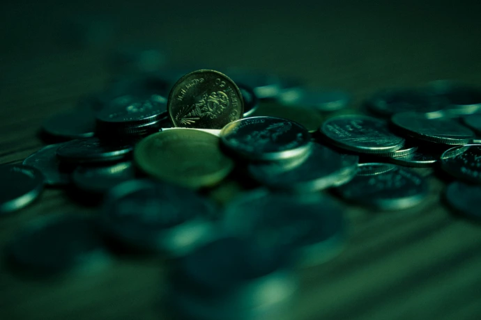 silver round coins on blue surface
